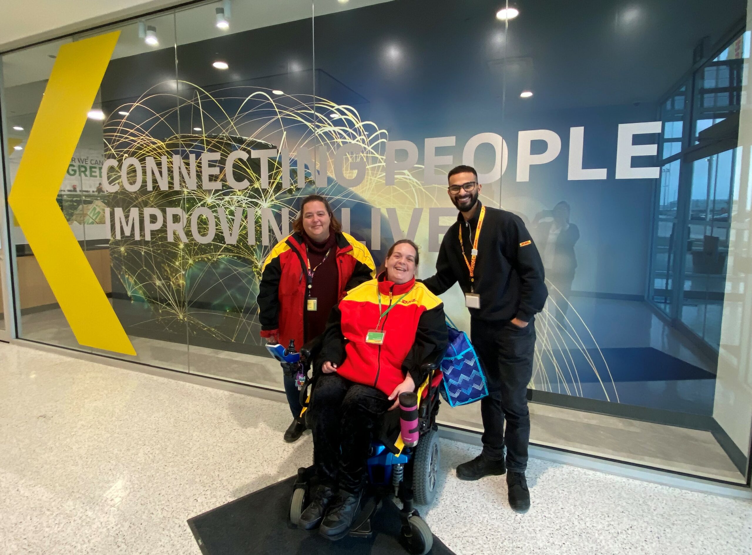 Leanne pictured in her DHL uniform alongside Ikram Muhammad and another colleague